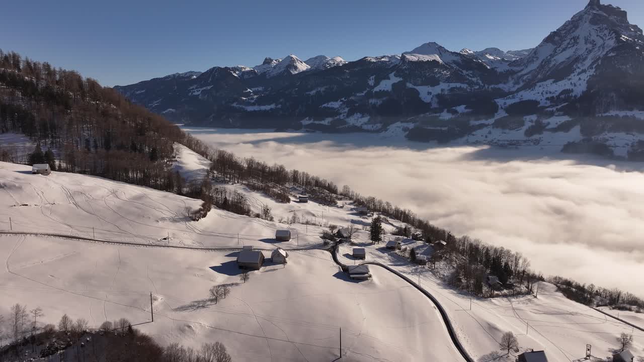 Snowy Swiss mountain village above the clouds with a serene winter landscape