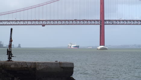 lisbon bridge with a fisherman's dock and a boat on the frame