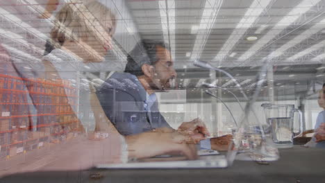 animation of aerial view of warehouse over diverse managers taking interview in office