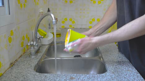 Male-person-doing-dishes-at-home