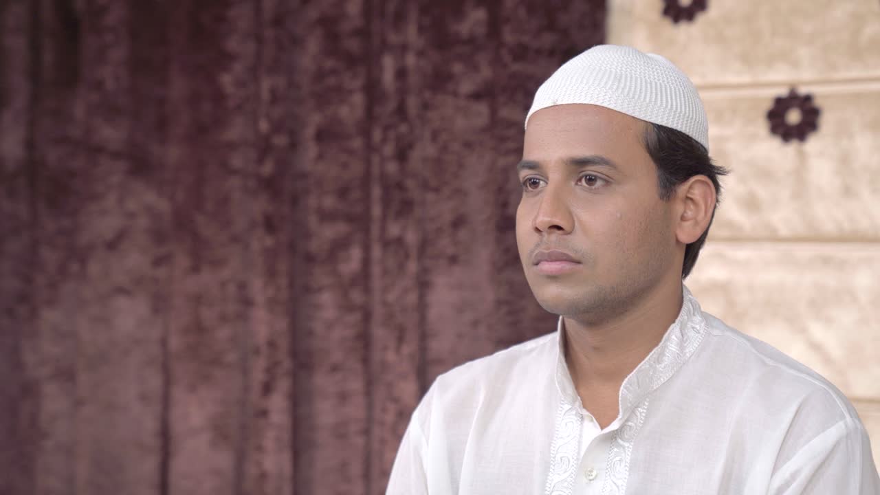 Serious Indian muslim man looking at someone