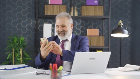 Happy-businessman-using-phone-laughing.