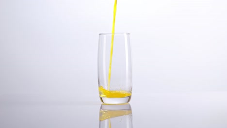 orange juice being poured into a glass
