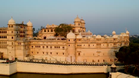 cinematic aerial sunset panning shot of udaipur city palace, rajasthan, india