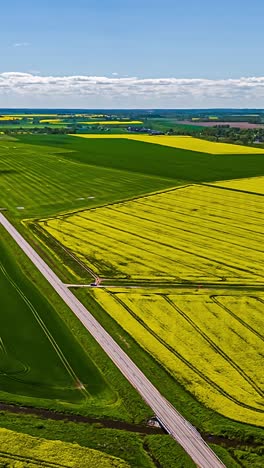 dynamic hyperlapse of green and yellow fields with shadows of clouds drifting across the landscape