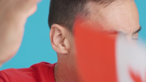 man with canadian national flag upset with a referee