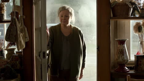 a woman stands in a doorway