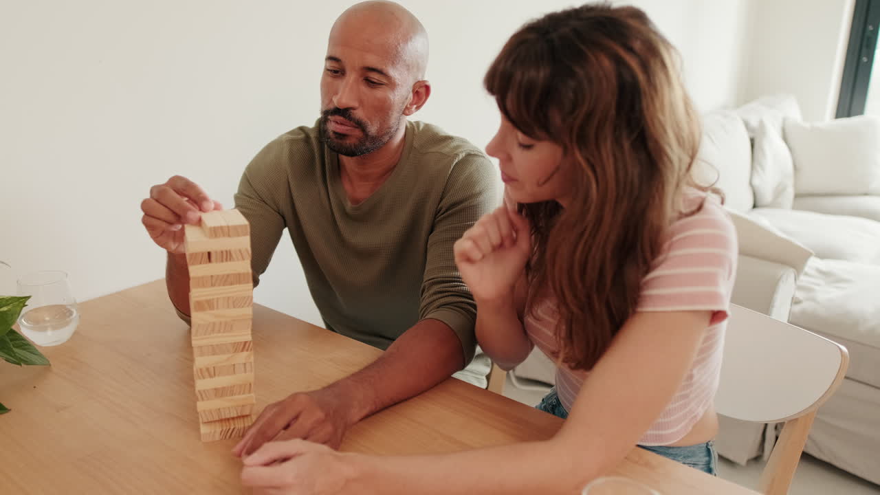 Couple Having Fun Playing Jenga at Home
