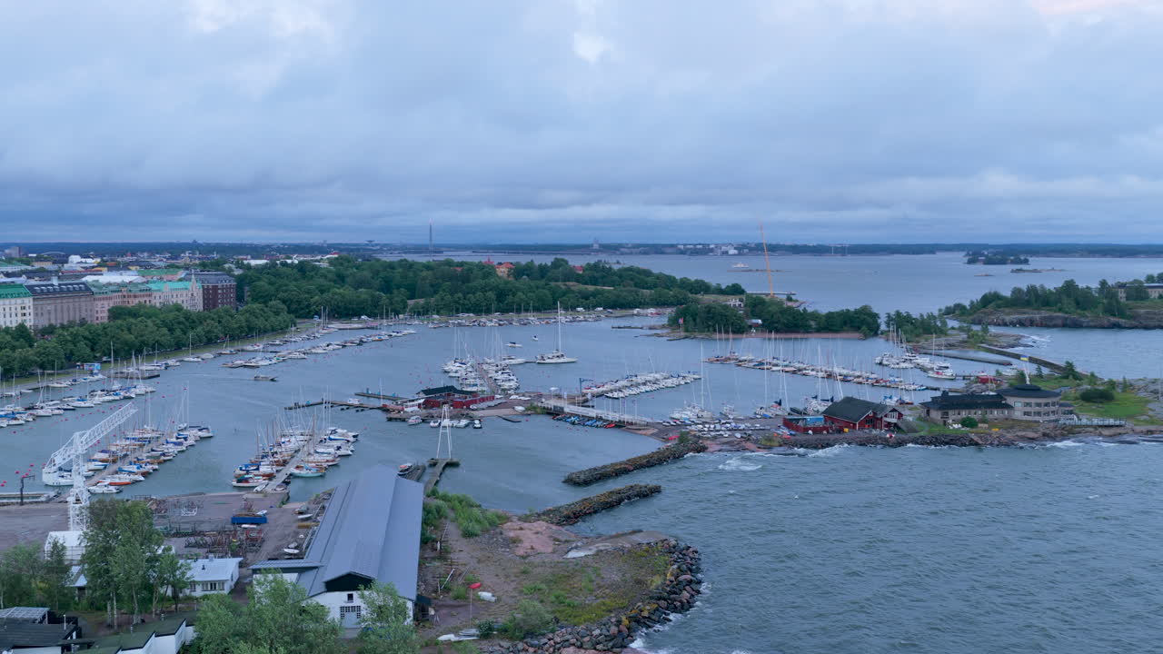 Aerial pan shot of waves hitting the Merisatama marina, windy evening in Helsinki