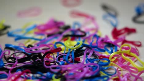 close up colorful rubber bands falling off