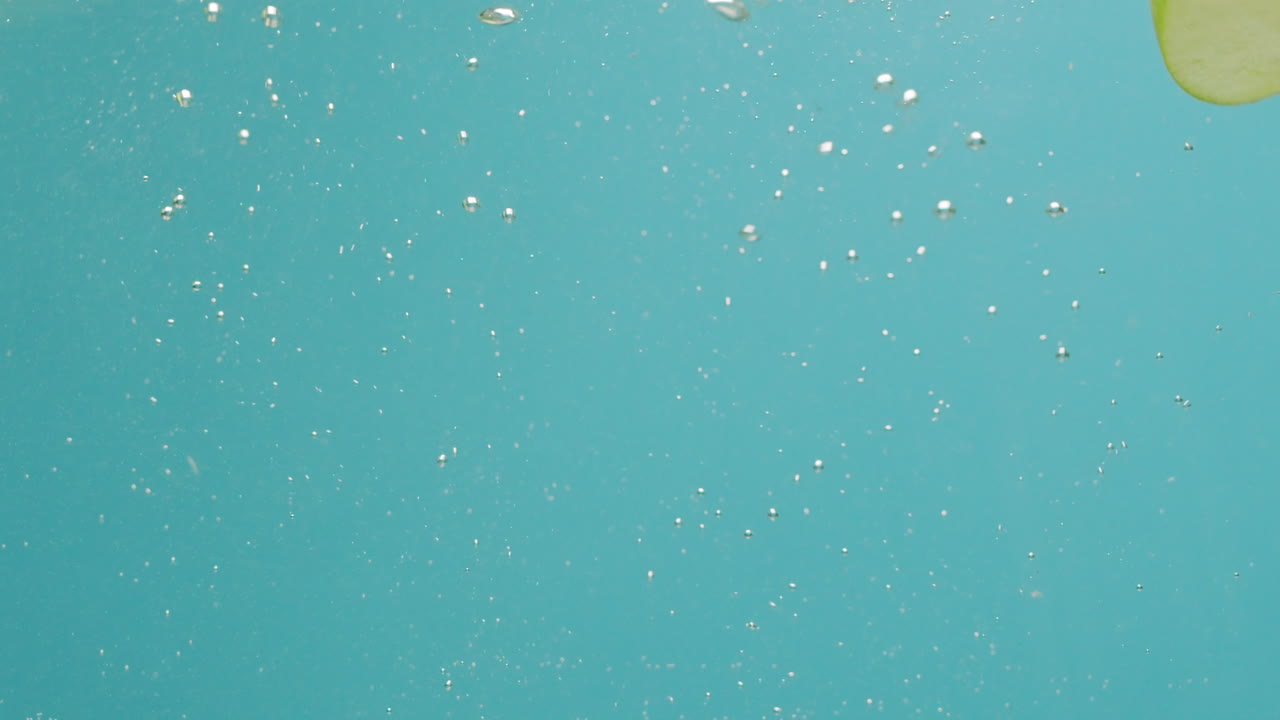 Green Apple Slices Underwater Splash