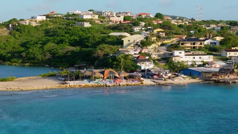 drone push in as calm waves crash over reef flats of boca sami to niffo huts on the coast, curacao