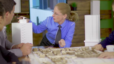 Female-senior-architect-having-a-discussion-with-her-young-team