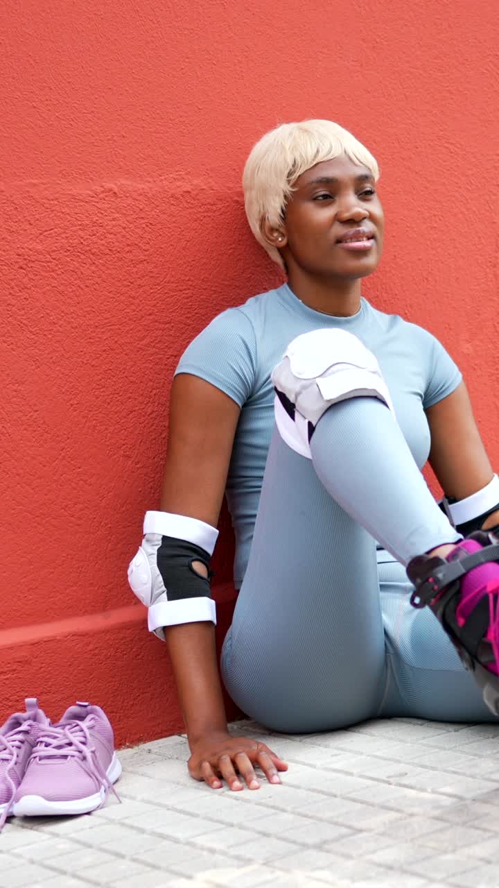 A woman wearing roller skates and protective gear