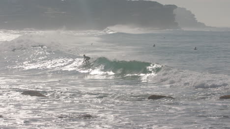 A-Surfer-pops-up-in-slow-motion-on-an-epic-wave-in-Manly-beach-Sydney-Australia