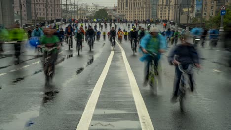 parade of bicyclists, bike riders  despite the bad weather, time lapse