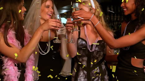 Confetti-animation-over-women-celebrating-with-champagne-glasses-at-party