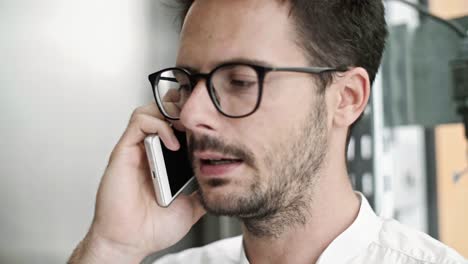 Man-talking-by-mobile-phone-in-the-elevator