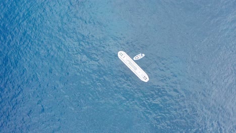 Panning-bird's-eye-aerial-shot-looking-down-at-a-submarine-in-the-open-ocean-off-the-coast-of-Kailua-Kona-on-the-Big-Island-of-Hawai'i