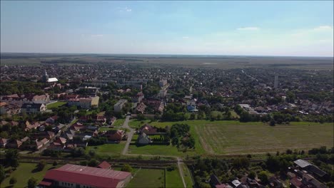 drone flying backwards over a small town