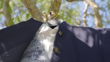 elegant men's suit hanging on a tree outdoors