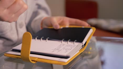 woman writing in calender notebook