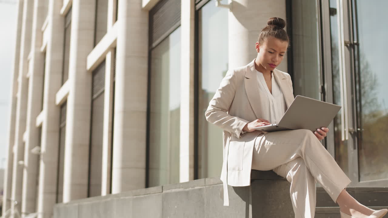 Businesswoman Working on Laptop Outdoors