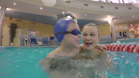 Boy-in-hugs-of-dear-mother-when-they-bathing-in-the-pool