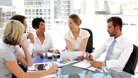 happy business people going over paperwork at meeting