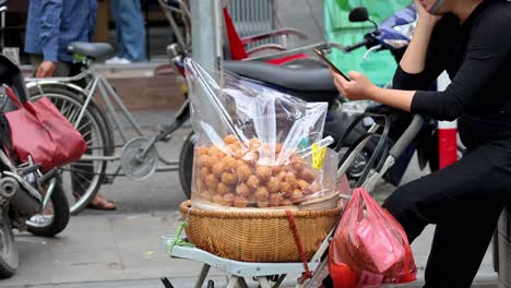 vendor selling desserts on a busy street