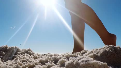 Woman-walking-on-the-sand