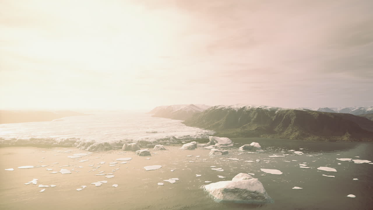 Glacial landscape with floating icebergs under a bright sky at dawn