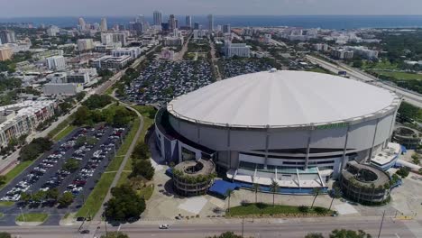 4k aerial drone video of tropicana field with waterfront skyline of downtown st