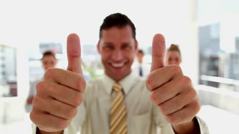 Businessman-standing-in-front-of-his-team