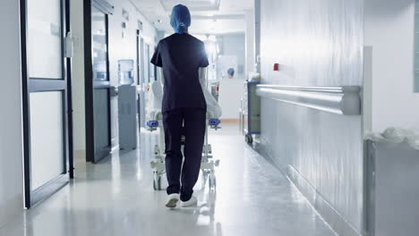 Patient,-bed-and-nurse-walking-in-hospital