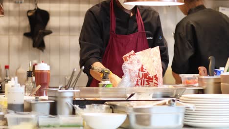 chef swiftly assembling a meal in a professional kitchen