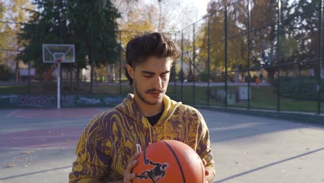 focused disabled man throwing basketball in open court.