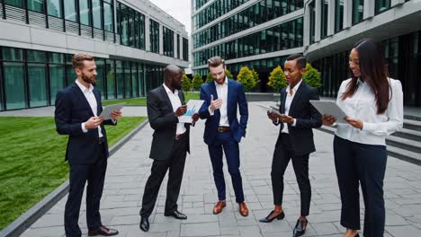 business team discussing data outdoors