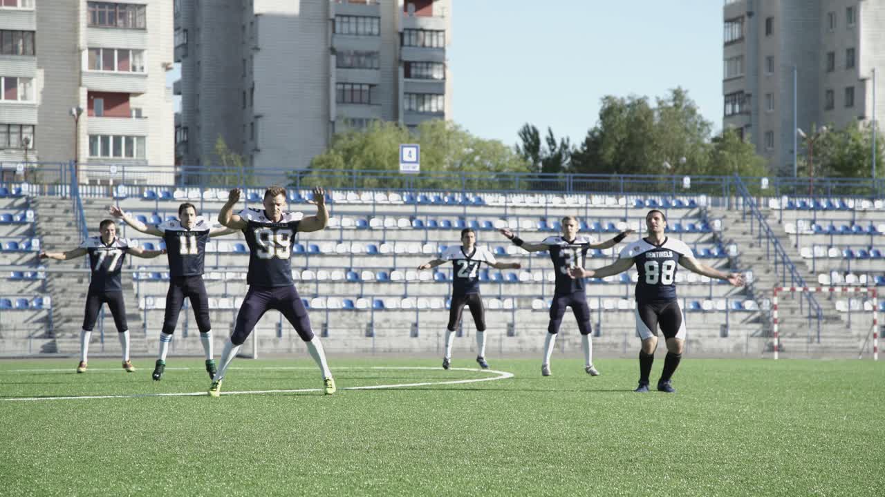미국 축구 선수 들 이 경기장 에서 몸 을 따뜻 하게 하고 있다