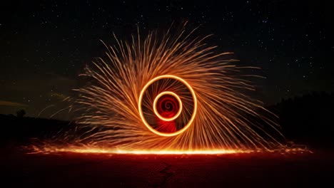captivating spiral of fire: an enchanting display of sparkling light in the night sky capturing the essence of movement and artistry through steel wool photography