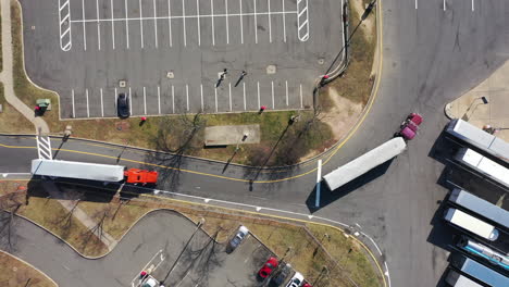 a top down shot over two trucks pulling in to a truck stop on a sunny day