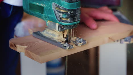 man using a jig saw to cut wood