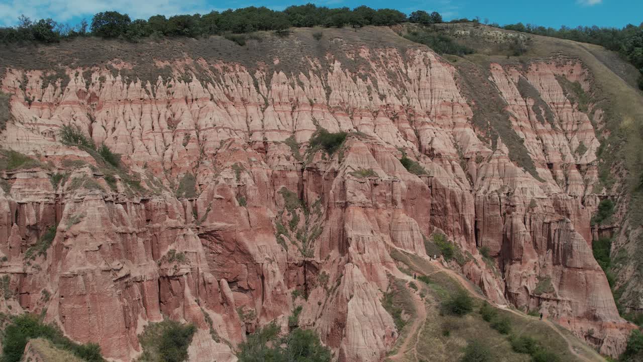 Epic Panoramic aerial view of Rapa Rosie red cliffs in Romania.