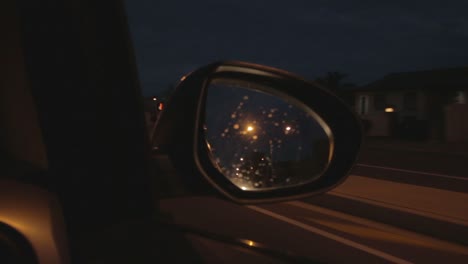 early morning driving car looking at side view mirror