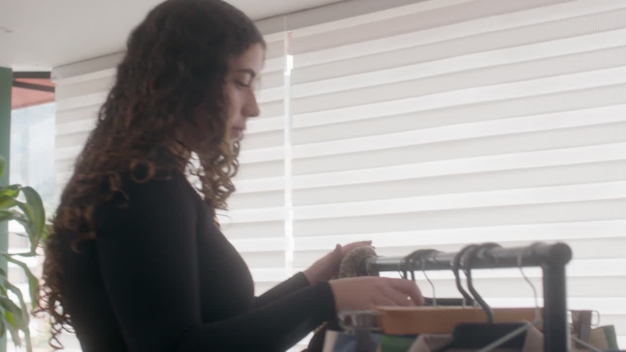 A woman's steps choosing clothes in her bedroom