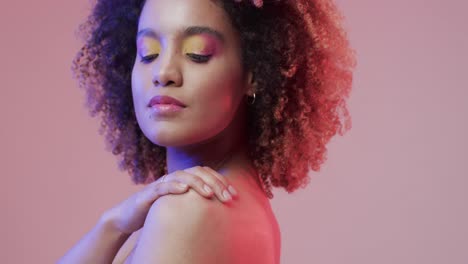 Biracial-woman-with-dark-hair-on-purple-background,-slow-motion