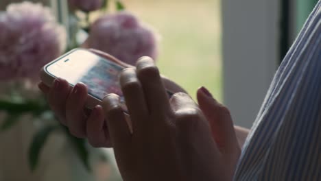 young woman scrolls through social media using smartphone