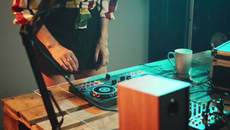 woman artist using stereo discs and amplifier to play songs