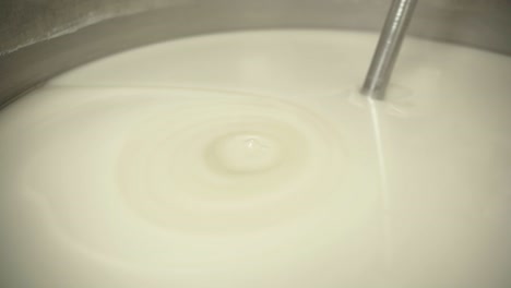 close-up view of white liquid mixing during pharmaceutical formulation.