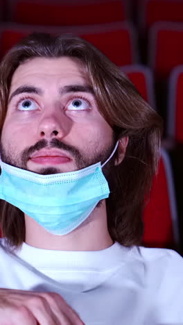 man watching movie in theater during pandemic